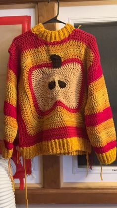 a crocheted sweater with a bear on it