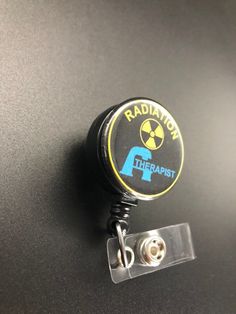 This unique retractable badge holder is adorable and useful. A great gift for any Radiation Therapist! These will be made with a belt clip back. If you prefer a swivel clip, let me know in the notes to seller section when checking out. Thank you!! :) Black Retractable Badge Holders As Gift, Black Retractable Badge Reel For Gift, Adjustable Black Retractable Badge Holder, Black Adjustable Retractable Badge Holders, Black Badge Reel With Swivel Clip As A Gift, Radiation Therapist Gifts, Radiation Therapist, Xray Tech, Therapist Gifts