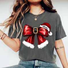 Comfort Colors Custom Christmas Coquette Bow Shirt, Merry Christmas Shirt,Trendy Christmas gift Tee, Christmas Mama Shirt,Xmas Santa Bow Shirt, 🌟 **Welcome to LazTeeApparel 🌟 **Product Details All of our T-Shirts are made from 100% semi combed Ringspun cotton, our T-shirts are high quality, heavy (190gsm) and super soft. --- Comfort Colors 1717 Unisex Heavyweight Tee Features--- 🌟6.1 oz./yd² (US), 10 oz/L yd (CA), 100% ring spun cotton, 20 singles 🌟Garment-dyed soft ring spun fabric 👕Relaxed fit 🔄 Topstitched, classic width, rib collar 👕Twill taped neck and shoulders 🔄 Twill label Our shirts employ the DTF (Direct to Film) printing method, ensuring vivid and lasting designs. **How to Order 1️⃣ Check out our detailed product photos for all available options. 2️⃣ Select your size and Casual T-shirt As Holiday Gift, Christmas Gift Short Sleeve T-shirt, Casual Christmas T-shirt As Gift, Holiday Gift Red T-shirt, Red Winter Top As Gift, Red Christmas Top As Gift, Red Christmas Tops As Gift, Red Christmas Top For Gift, Graphic Print Top As Christmas Gift