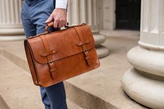 Full Grain Vegetable Tanned Bridle Leather Briefcase | Esq. Briefcase - Jackson Wayne Leather Goods Business Bags With Brass Hardware And Top Handle, Cognac Satchel For Business Trips, Cognac Satchel Briefcase With Luggage Sleeve, Classic Laptop Bag With Leather Handles For Business Trips, Business Bags With Brass Hardware In Cognac, Cognac Business Bag With Brass Hardware, Classic Top Handle Satchel With Luggage Sleeve, Timeless Cognac Briefcase For Work, Timeless Cognac Smooth Grain Briefcase