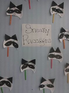 some raccoons are made out of paper on sticks with the words sneaky raccoons written on them