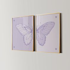 two purple butterfly paintings hanging on the wall