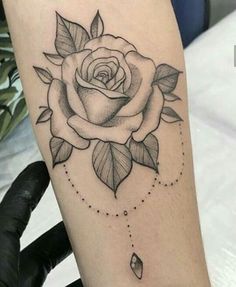 a black and white rose tattoo on the arm