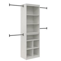 an empty white shelf with four shelves and two black metal bars on the bottom half of it