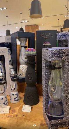 there are many vases on display in the store