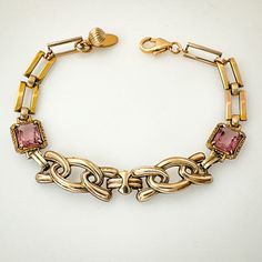 "Unique one-of-a-kind Art Deco era link bracelet featuring vintage repurposed gold filled and gold filled over sterling links - two have a pink rhinestone accent.  The closure is a gold filled lobster claw design with jump ring on the opposite end along with a gold filled bead accent.  This bracelet looks fabulous on - perfect gift for the woman who loves unique jewelry that nobody else will be wearing.  I can add a couple more jump rings to the end if you need some extra length; simply contact me to discuss. Details *Measures 7 1/4\" length x 3/8\" across *Combination of gold filled and gold filled over sterling vintage links *Pink rhinestone accents *Gold filled closure *Bracelet weighs 10.8 grams *Ready to ship and sent in a gift box Condition:  All elements are authentic vintage in ver Yellow Gold Metal Bracelet With Vintage Charm, Vintage Yellow Gold Bracelets With Jewels, Vintage Yellow Gold Bracelet With Rectangular Links, Vintage Yellow Gold Bracelet With Jewels, Vintage Gold Bracelet With Rectangular Links, Gold Brass Bracelets, Vintage Yellow Gold Brass Chain Bracelet, Vintage Gold Bracelets With Rectangular Links, Vintage Yellow Gold Chain Bracelet With Rectangular Links