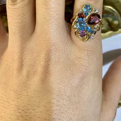 Metal: 14K Gold                                                                                                                                                                                                                                                                                                           Stone: Garnet, Blue Topaz , Amethyst And Diamond  Shape: Round, Pear-shape And Oval                                                                                                                                Approximate Gem Weight: 4.00 Carats Oval Multi-stone Ruby Ring In Yellow Gold, Oval Multi-stone Ruby Ring In 14k Gold, 14k Gold Multi-stone Ruby Ring, 14k Gold Multi-stone Oval Ruby Ring, Colored Diamond Rings, Gold Stone, Matching Band, Multi Stone Ring, Diamond Shape