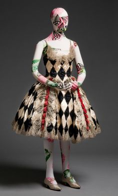 a woman dressed in an elaborate dress and makeup