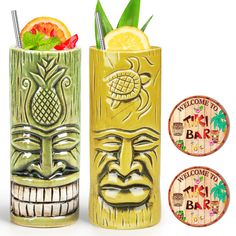 two tiki mugs with drinks in them next to each other