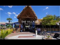 the village shop and dine is located in an area that looks like a tropical resort