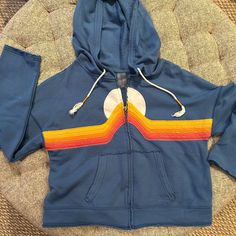 Blue Hoodie With Rainbow Stitched On Front, Frayed Edges On Sleeves, Along The Rainbow, And The Bottom Of Hoody, Never Worn, But No Tags, Great Condition, Size M Hooded Jean Jackets, Collar Vest, Under Armour Sweatshirt, Pleated Jacket, Black Puffer Vest, Zipped Hoodie, Satin Jackets, Blue Hoodie, Boys Hoodies