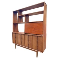 a wooden bookcase with drawers and doors on the front, against a white background