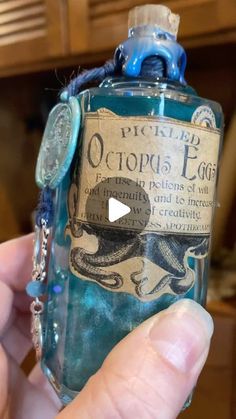 a person holding a bottle with an octopus on it