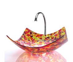 a colorful glass bowl hanging from a hook on a white background with reflections in the floor