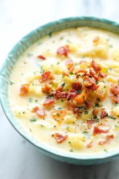 a blue bowl filled with soup on top of a table