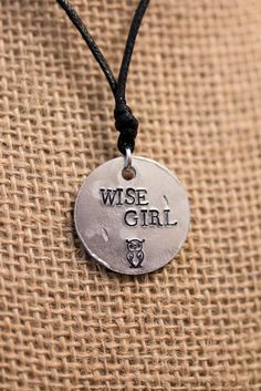 "If you didn't already know, one of the lead female heroines is Annabeth Chase, daughter of Athena. In the Lightning Thief, she's given the nickname \"Wise Girl\" by the lead hero, Percy Jackson. I present to you, my Percy Jackson inspired \"Wise Girl\" necklace. PRODUCT INFORMATION: - Made on a 1 inch aluminum blank (wearer friendly) - Hangs on a black adjustable cord, about 26 inches at the largest setting - The words \"WISE GIRL\" and an owl are stamped on the pendant - Pendant made to look b Annabeth Aesthetic, Percy Jackson Jewelry, Percy Jackson Crafts, Chase Aesthetic, Annabeth Chase Aesthetic, Daughter Of Athena, Sister Aesthetic, Jackson Aesthetic, Female Heroines