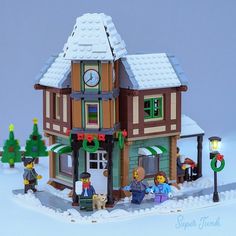 a lego house with people and a dog outside in the snow