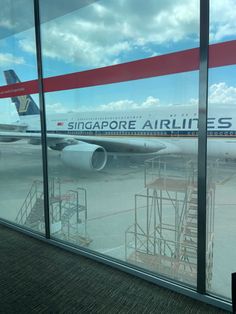 an airplane is sitting on the tarmac at singapore airlines's terminal in hong kong