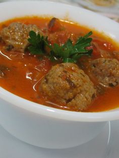 a white bowl filled with meatballs and tomato sauce