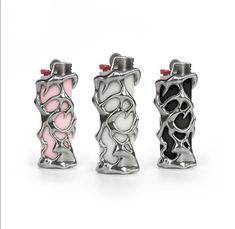 three lighters with different designs and colors on the top one is pink, white, and black