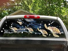 a truck with turtle decals on it's back window