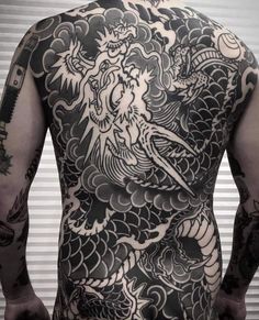 the back of a man with tattoos on his body