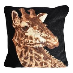 a pillow with a giraffe on it's face in gold and black