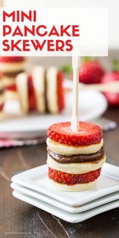 mini pancake skewers are stacked on top of each other with strawberries