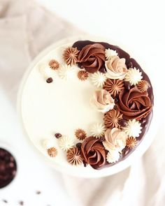 a white cake with chocolate frosting and flowers on top