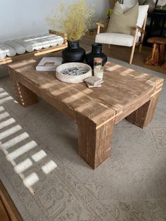 a wooden table sitting in the middle of a living room