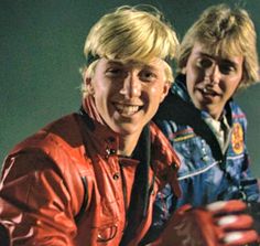 two young men in leather jackets posing for a photo