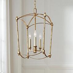 a chandelier with three candles hanging from it