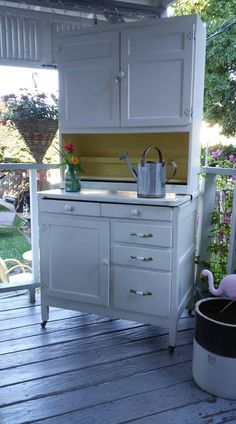 an old fashioned white kitchen on a deck