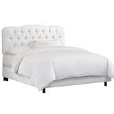 a white bed with tufted upholstered headboard and foot board, on a white background