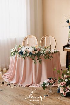 the table is set up with chairs and flowers on it for an elegant wedding reception