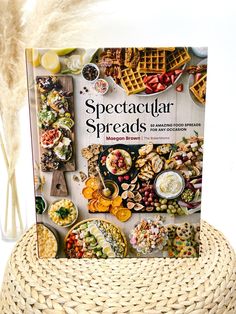 the book spectacular spreads is sitting on top of a wicker basket