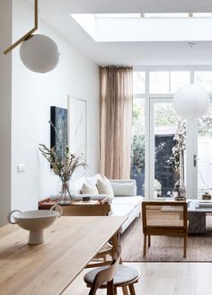 a living room filled with furniture and lots of windows