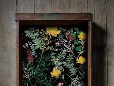 a wooden frame with flowers and leaves painted on it