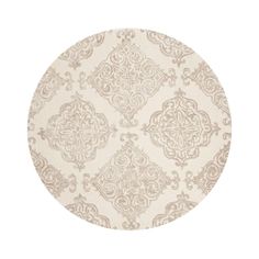 a round rug with an intricate design on the top and bottom, in beige tones