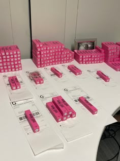 pink legos are stacked on top of each other at the same time, with price tags attached to them