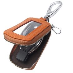 a cell phone in a pouch with a key chain hanging from it's side