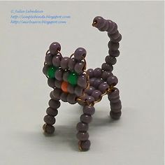 the beaded cat is standing on its hind legs