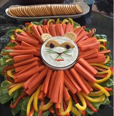 a lion face made out of carrots and crackers