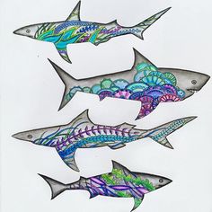 three fish are swimming in the water with colorful designs on their backs and sides,