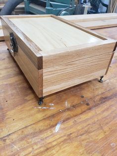 a wooden box sitting on top of a hard wood floor