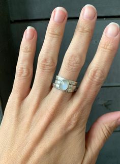 A stunning oval white moonstone has been set in sterling silver with two accenting ring bands! This lovely moonstone stone is 10mm x 8mm in size. It has been set in sterling silver with a handmade ring band from 3mm sterling silver rectangle wire. Each ring band has been hand hammered. Wear all three together as a stacked ring or separately. Made to order! Choose your size and gemstone! Moonstone, pink chalcedony, white howlite, aqua chalcedony, and green prehnite!Also available in a horizontal White Stackable Moonstone Rings With Ethical Gemstones, Oval Moonstone Gemstone Stackable Rings, Oval Moonstone Stackable Rings With Gemstone, Silver Moonstone Stackable Rings, White Moonstone Stackable Rings For Promise, Stackable Rings With Moonstone Gemstones, Silver Stackable Moonstone Ring For Anniversary, Stackable Silver Moonstone Ring For Anniversary, White Moonstone Stackable Rings