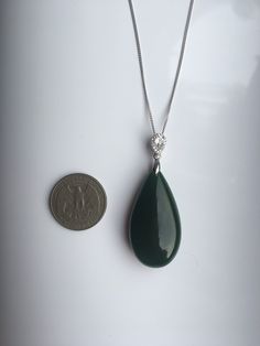 A gorgeous dark green jade pendant necklace. The big teardrop pendant comes with shiny diamond-like small teardrop stones and a 925 sterling silver necklace. Simple but elegant. Perfect as a gift for yourself or your loved ones. Highlights of this breath-taking teardrop round jade pendant are: ＊High-quality materials Made from quality jade and 925 sterling silver. Friendly to sensitive skins and ensure long-lasting color ＊Simple & Elegant Minimalistic style goes well with all sorts of occasi Jade Teardrop Pendant Gemstone Jewelry, Green Jade Teardrop Pendant Jewelry, Elegant Green Pendant Drop Necklace, Green Teardrop Gemstone Drop Necklace, Elegant Jade Drop Jewelry, Elegant Teardrop Jade Jewelry, Elegant Dark Green Jade Jewelry, Green Jade Necklace, Mother Photos