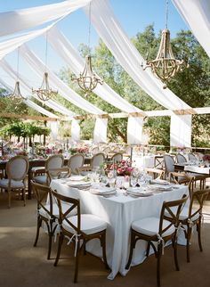 an instagram page with tables and chairs covered in white draping