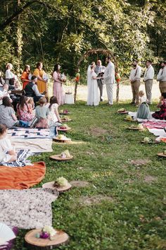 Outdoor Wedding with blanket and wooden chair seating for guests. Wooden slabs for bridal party entrance. 
Wedding arch made out of sticks. Colorful summer wedding. Bridesmaids alternatives, bouquet Bridesmaids holding wicker fan. Groomsmen in suspenders. Rainbow colors for wedding. Wedding Seat Ideas Outdoor, Picnic Blanket Wedding Seating, Picnic Style Wedding Ceremony, Picnic Ceremony Wedding, Picnic Blanket Wedding Ceremony, Outdoor Picnic Wedding Ideas, Wedding Picnic Blankets