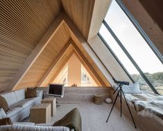 a living room filled with furniture and a skylight in the corner of a building